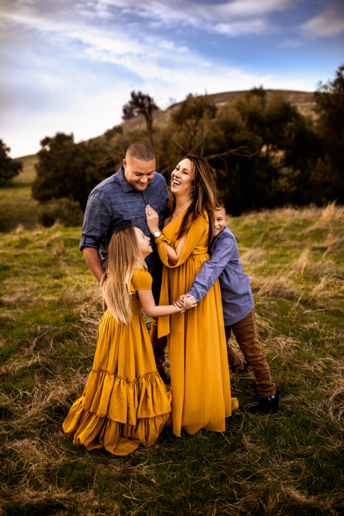 Family Photographer, family of four smiling and hugging